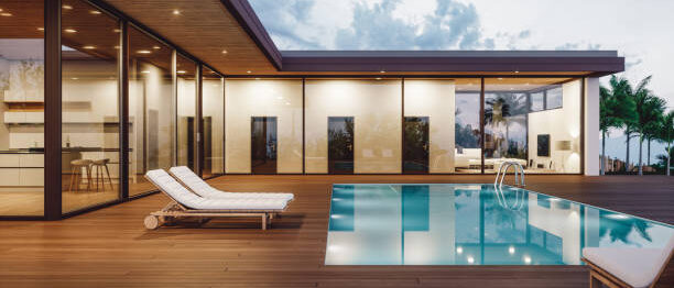 Modern luxury villa with private swimming pool at dusk.